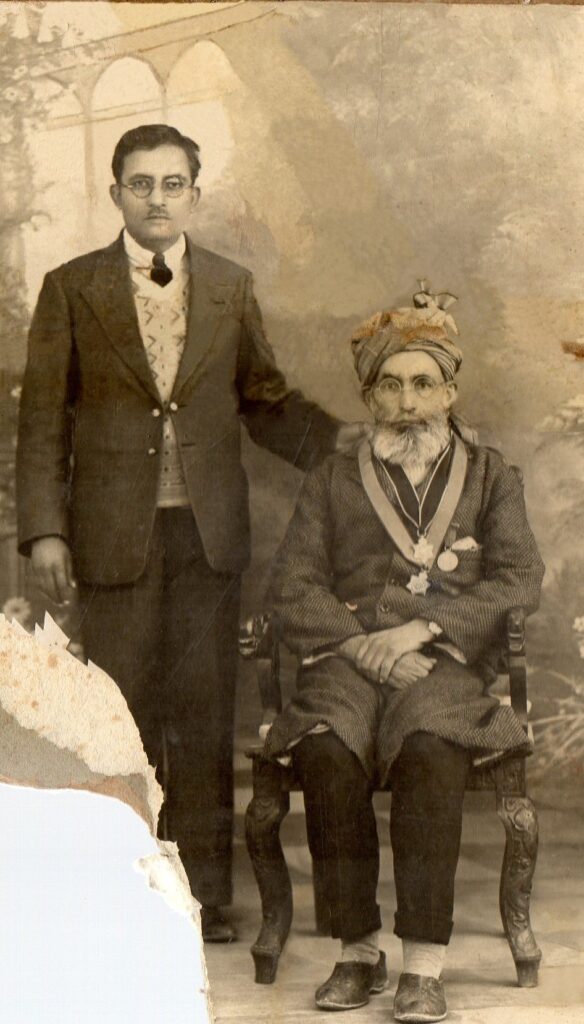 Hazrat Khan Bahadur Ghulam Muhammad Khan sahib seated with his son in law Hazrat Sheikh Muhammad Mubarak Ismael sahib standing